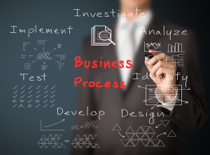 A man writing a concept of a business process